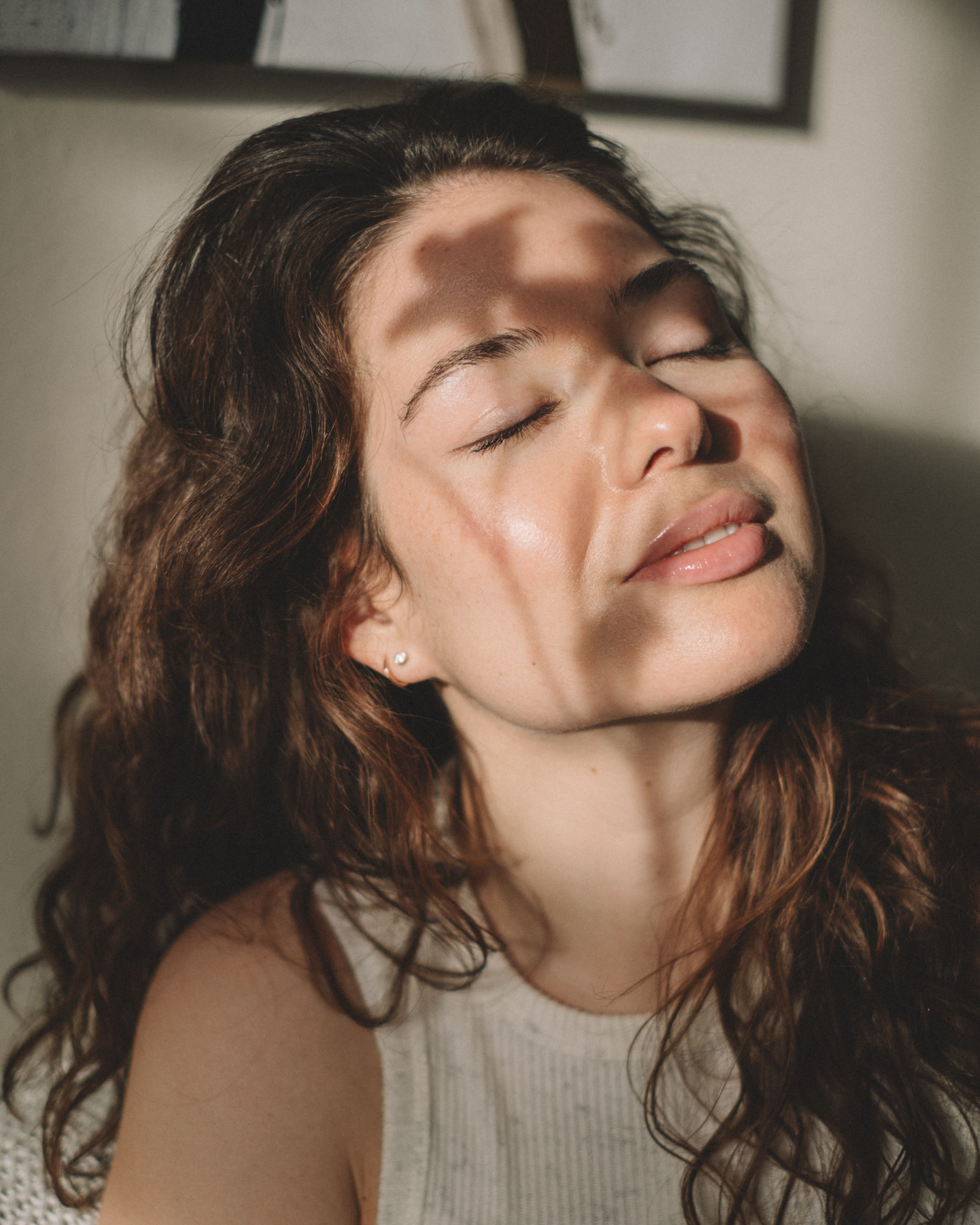 Woman with closed eyes resting in warm afternoon light